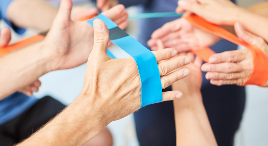 Two people using bands during physical therapy.